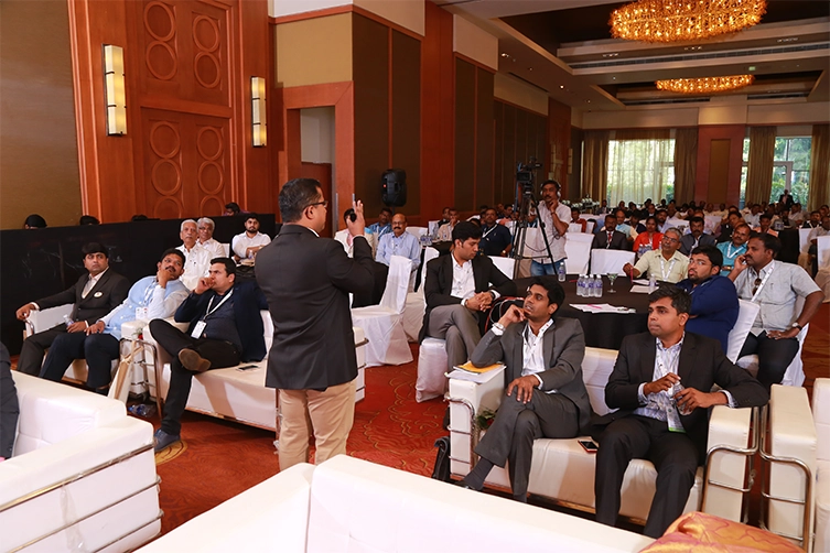 Speaker addressing real estate leaders during conference session focused on growth and leadership