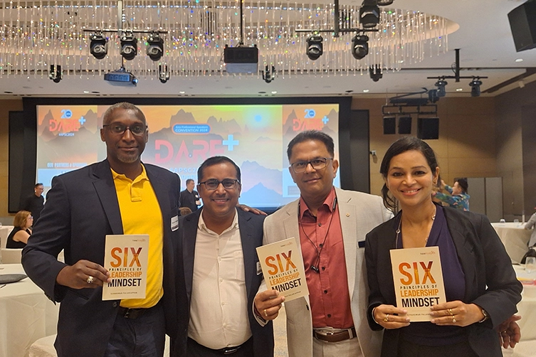 Keynote speaker attends international book release in Singapore, sharing leadership growth insights.