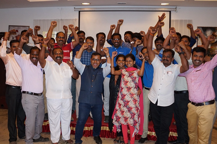 Leadership keynote speaker coaches professionals on public speaking skills at corporate workshop.