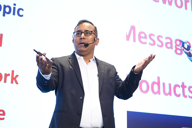 Motivational keynote speaker on stage at the corporate growth leadership conference in Mumbai.